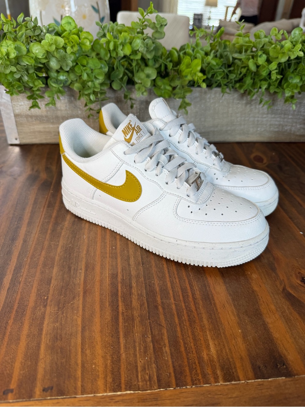 Nike White Low-Top Sneakers with Gold Swoosh